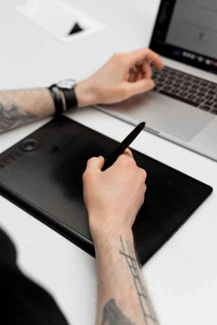 A sleek office desk setup featuring Apple devices: iMac, MacBook, and iPad.